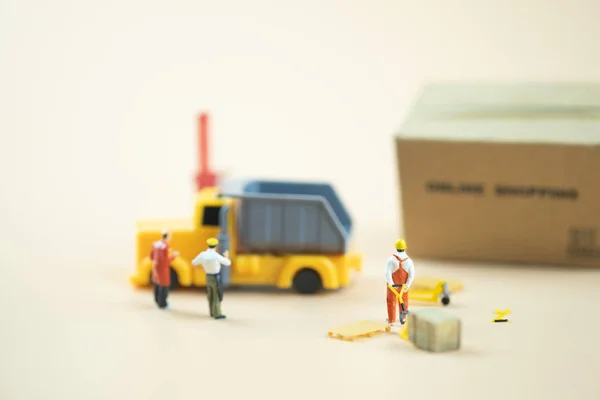Miniature people : Worker team moving order from online shopping. Concepts of logistics and transportation