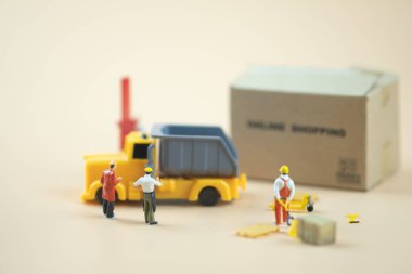 Miniature people : Worker team moving order from online shopping. Concepts of logistics and transportation