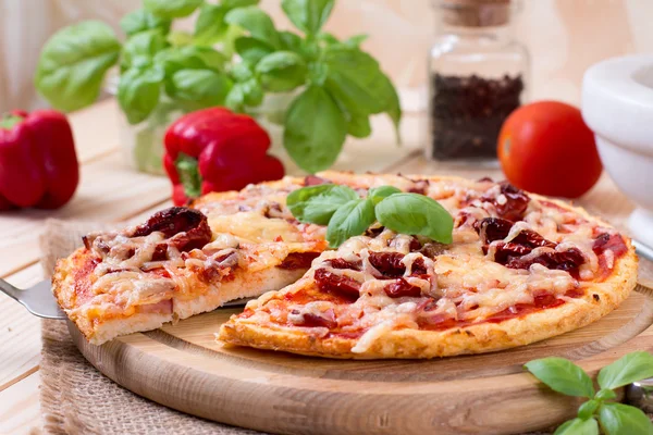 Tasty pizza on wooden table — Stock Photo, Image