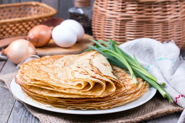 Pancakes with greens on a wooden background — Stock Photo, Image