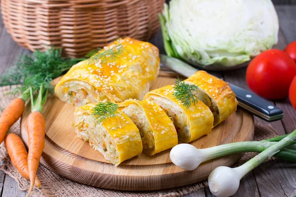 Roll with cabbage on a wooden board — Stock Photo, Image