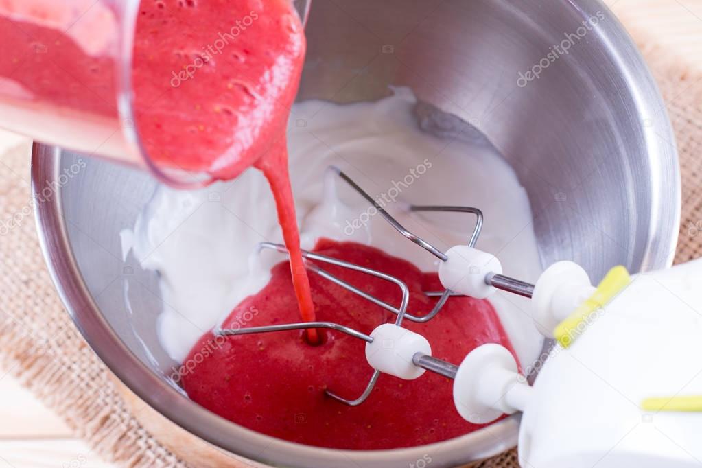 Berry juice in cream in a metal bowl