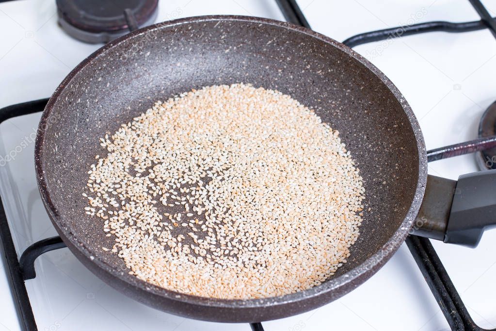 sesame seeds are fried in the pan