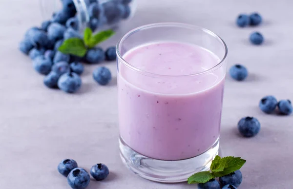 Homemade blueberry yogurt in a glass on white wooden background — Stock Photo, Image