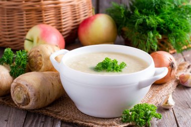 Parsnip soup with parsley and vegetables clipart