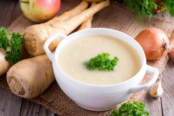 Parsnip cream soup on a wooden board Stock Image