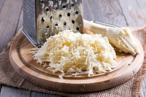 Grated parsnip on cutting board — Stock Photo, Image