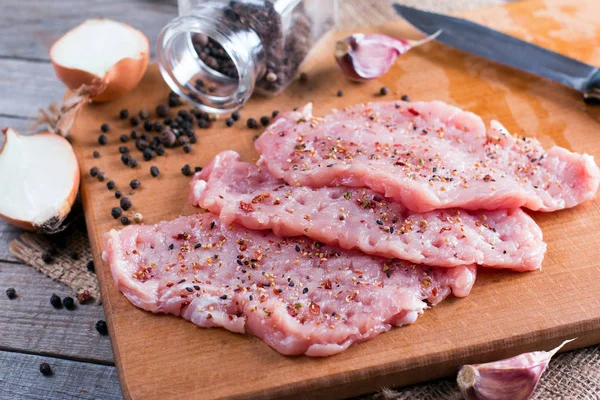 Свежая сырая свинина отбивные мясо с молотком мяса на доске — стоковое фото