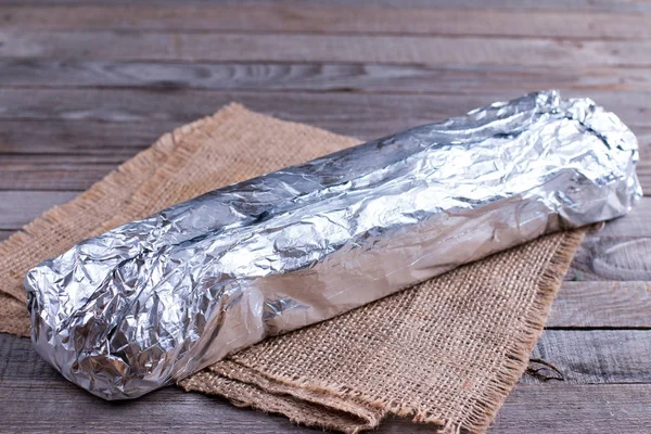 Roll in foil on a table — Stock Photo, Image