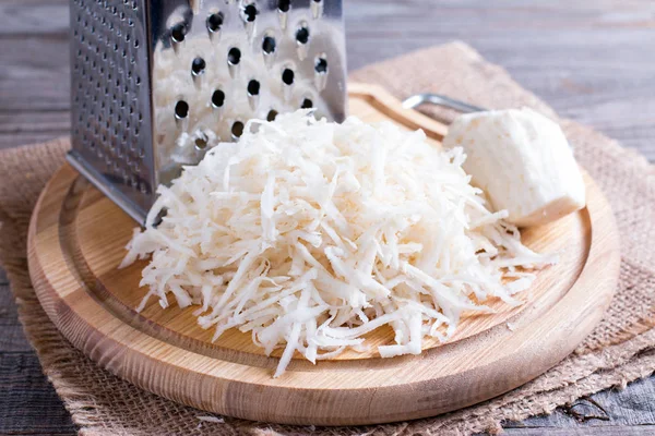 Celery root (celeriac) grated for a salad — Stock Photo, Image