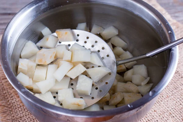 Cubes of celery root in ice water — Stock Photo, Image