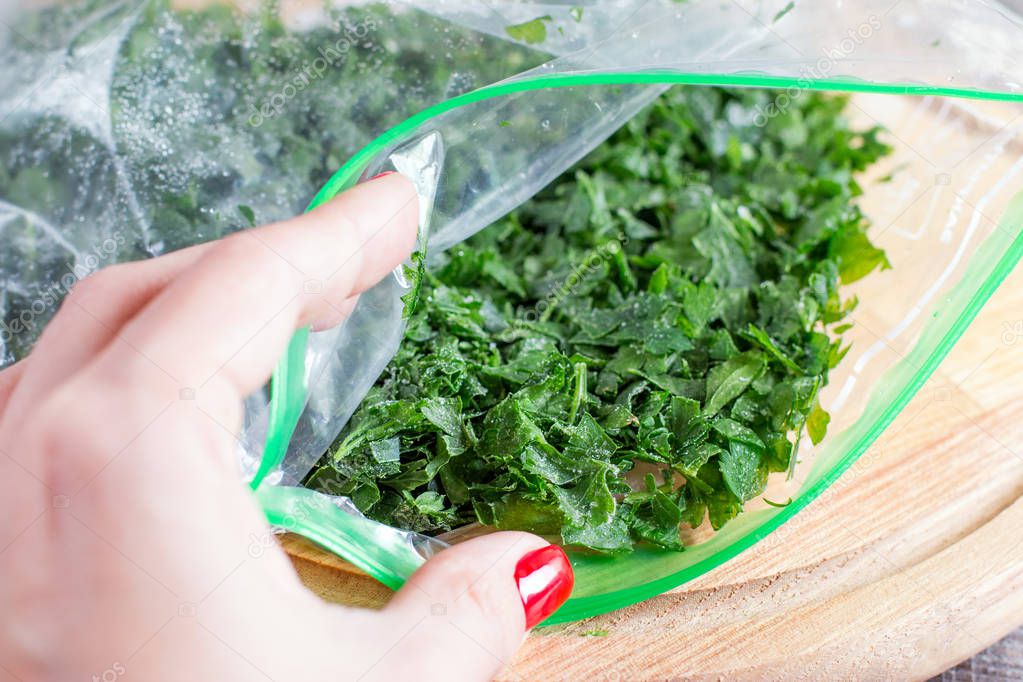 Frozen greens in a bag on a cutting board
