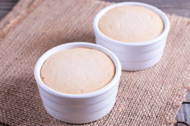 Ahşap bir masa beyaz seramik ortamda süzme peynir güveç