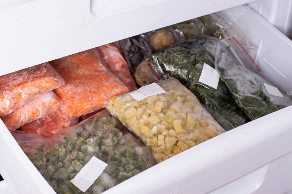Assortment of frozenVegetables in home fridge. Frozen food in the refrigerator.