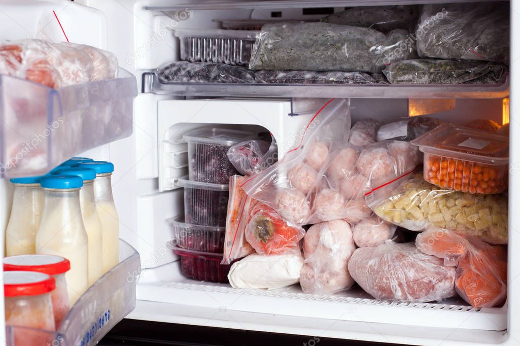Refrigerator with frozen food (meat, milk, fruits and vegetables)