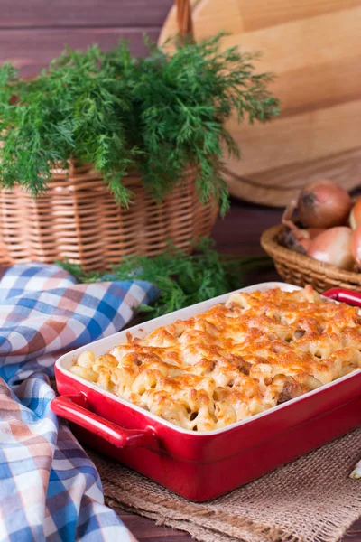 Pasta casserole with cheese and ham with tomato and cream sauce — Stock Photo, Image