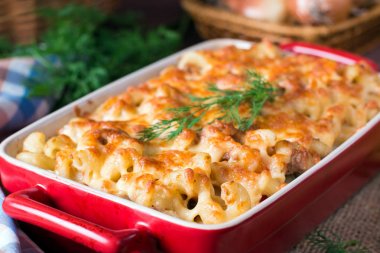Pasta casserole with cheese and ham with tomato and cream sauce clipart