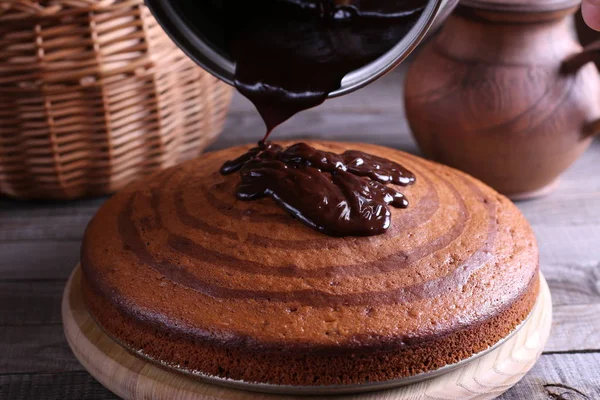 Pie with chocolate icing on wooden table. Delicious zebra marble cake. — Stock Photo, Image