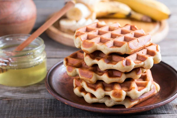Homemade Belgian waffles with with bananas and honey on a plate — Stock Photo, Image