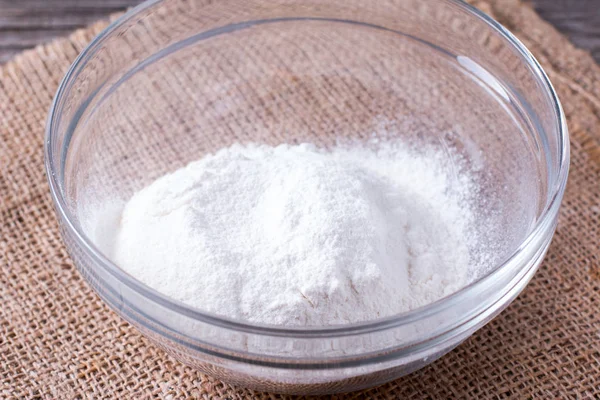 Flour in glass bowl on the wooden table — Stock Photo, Image