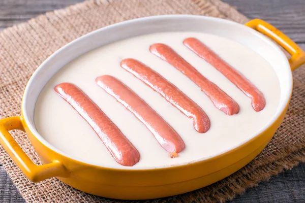 Preparation Toad in the hole - traditional British dish consisting of sausages in Yorkshire pudding batter