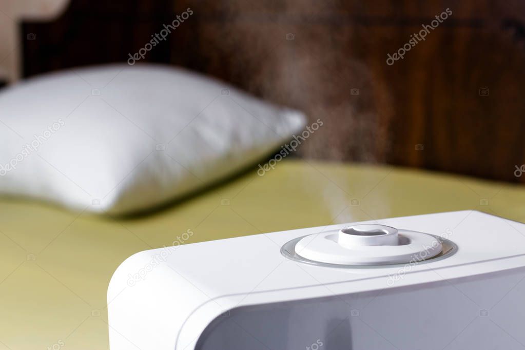 Vapor from humidifier in the bedroom. Ultrasonic humidifier in the house.