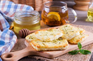 Bir kesme tahtası üzerinde otlar peynirli ızgara haloumi