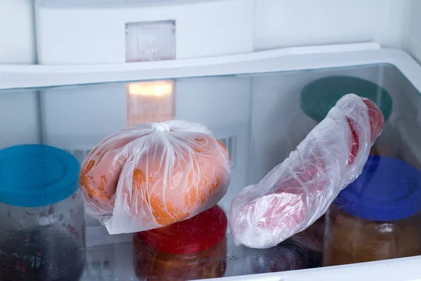 Sausages in a bag in the freezer. Frozen food — Stock Photo, Image