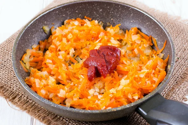 Cebolla de tomate zanahoria y pasta de tomate en una sartén — Foto de Stock