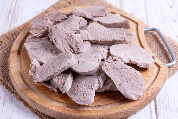 Sliced boiled meat, pork on a cutting board — Stock Photo, Image