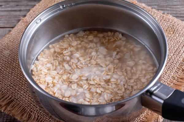 Oatmeal porridge in a saucepan — Stok fotoğraf