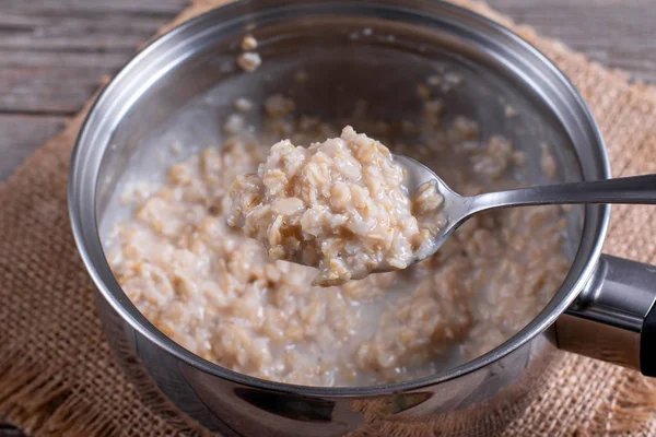 Oatmeal porridge in a saucepan — Stok fotoğraf