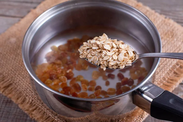 Oatmeal porridge in a saucepan