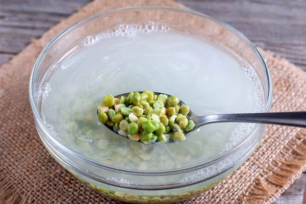 Soaking peas in a water — Stock Photo, Image