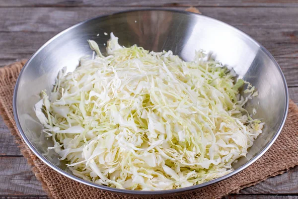 Shredded cabbage on wooden cutting board — Stock Photo, Image