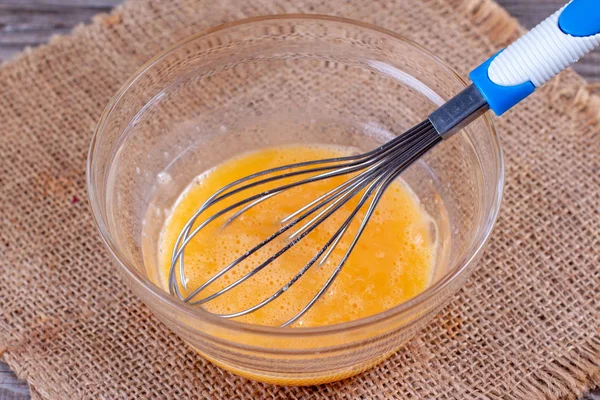 Whisking eggs in a glass bowl