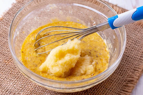 Grated apple and raw egg in a glass bowl. Making cupcake — Stock Photo, Image