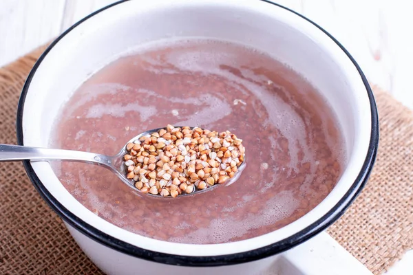 Green buckwheat in a spoon — Stock Photo, Image