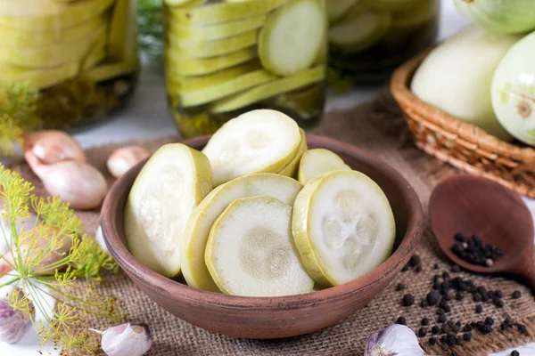 Pickled zucchini in glass jar on a wooden table — Stock Photo, Image