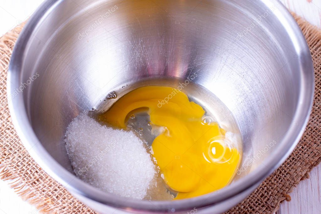 Egg and sugar in a metal bowl