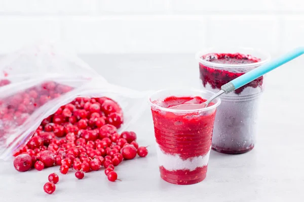 Frozen berry puree and frozen berries on white background — Stock Photo, Image