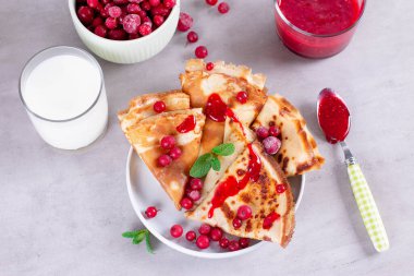 İnce krep ya da krep seramik tabakta reçel ve donmuş böğürtlen, nane