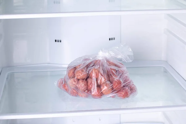 Frozen Meatballs in a plastic bag in refrigerator