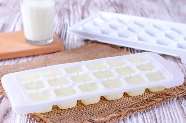 Ice Cube Tray Frozen Milk White Wooden Table Closeup — Stock Photo, Image
