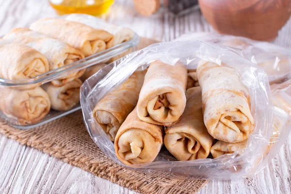 Frozen Stuffed Pancakes Plastic Bags Table — Stock Photo, Image