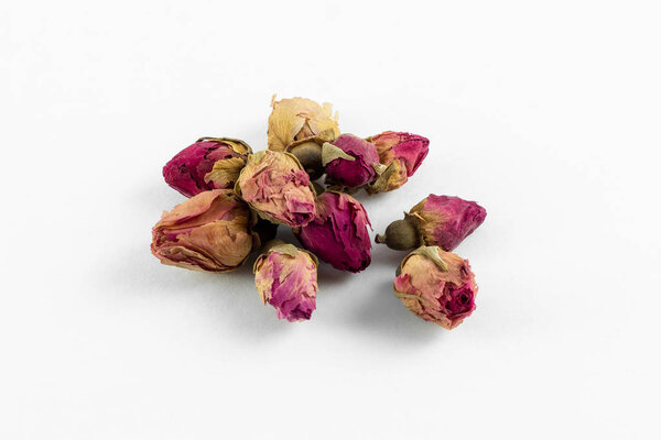 red and pink rose buds tea on white background