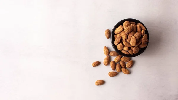 Natural Organic Almonds Black Bowl Top View Royalty Free Stock Photos