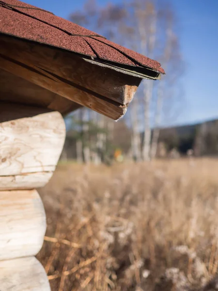 Hoek van een houten hut met uitzicht op de natuur — Stockfoto