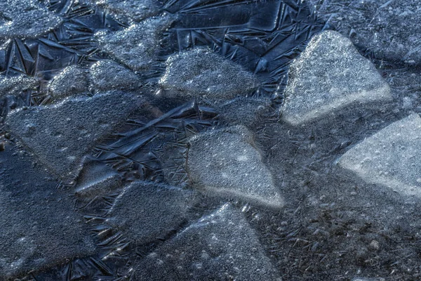 Many small cracked ice sheets on a lake — Stock Photo, Image
