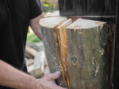 Firewood split with wooden splitter clipart
